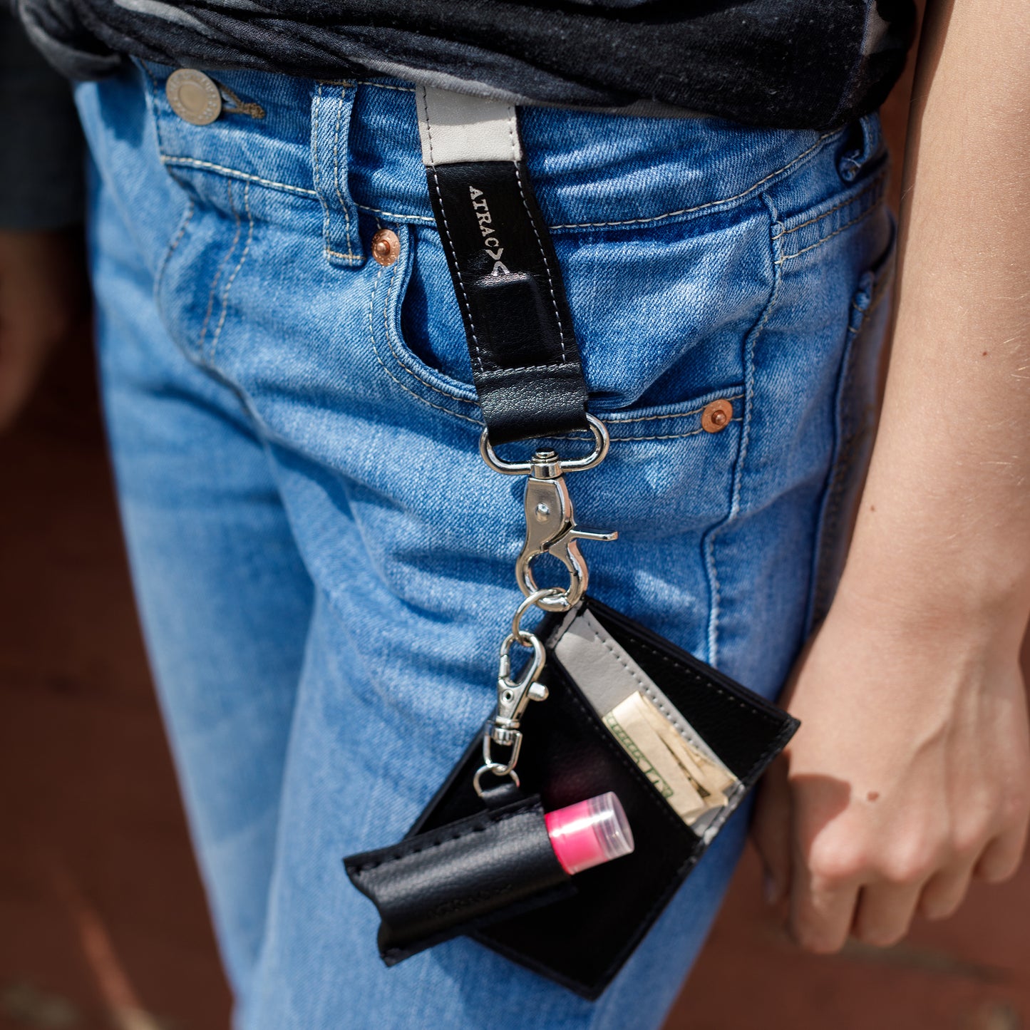 black and gray vegan leather bracelet, keychain, and a three pocket wallet, with lip balm holder.