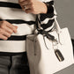 A black vegan leather Keychain Bracelet on bag