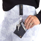 black and gray vegan leather bracelet, keychain, and a three pocket wallet,  with lip balm holder.